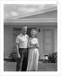 1950s Older Man Woman Senior Citizen Standing Together In Retirement Home Front Yard by Anonymous