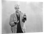 1930s Dour Man In Lab Coat Holding Bottle Of Poison by Anonymous