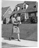 1940s Woman Walking Shopping Carrying Grocery Bag On Suburban House Sidewalk by Anonymous