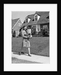 1940s Woman Walking Shopping Carrying Grocery Bag On Suburban House Sidewalk by Anonymous