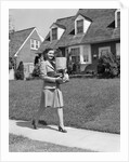1940s Woman Walking Shopping Carrying Grocery Bag On Suburban House Sidewalk by Anonymous