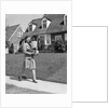 1940s Woman Walking Shopping Carrying Grocery Bag On Suburban House Sidewalk by Anonymous