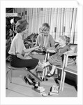 1960s Mother Daughter Shoe Shopping Saleswoman Showing Patent Leather Shoe To Girl by Anonymous
