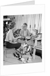 1960s Mother Daughter Shoe Shopping Saleswoman Showing Patent Leather Shoe To Girl by Anonymous
