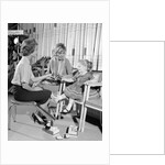 1960s Mother Daughter Shoe Shopping Saleswoman Showing Patent Leather Shoe To Girl by Anonymous