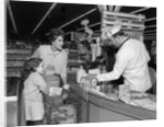 1960s Mother Daughter Unload Grocery Cart At Supermarket Checkout Counter by Anonymous