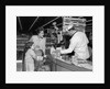 1960s Mother Daughter Unload Grocery Cart At Supermarket Checkout Counter by Anonymous