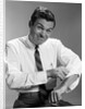 1960s Man In Business Shirt And Tie Rolling Up His Sleeves To Work Determined Look Studio by Anonymous
