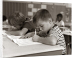 1960s Boy Striped T-Shirt Elementary School Classroom Sitting Desk Writing Test by Anonymous