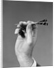 1960s 1970s Hand Close-Up Holding About To Throw A Sharp Pointed Dart by Anonymous