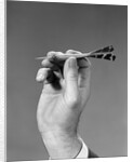 1960s 1970s Hand Close-Up Holding About To Throw A Sharp Pointed Dart by Anonymous