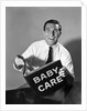 1960s Man Father Holding Baby Care Book by Anonymous