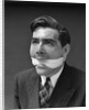 1930s Portrait Of Man With Gag In Mouth by Anonymous