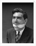 1930s Portrait Of Man With Gag In Mouth by Anonymous