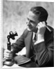 1920s Businessman Talking Into Candlestick Telephone by Anonymous