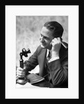 1920s Businessman Talking Into Candlestick Telephone by Anonymous