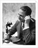 1920s Businessman Talking Into Candlestick Telephone by Anonymous
