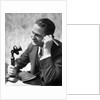 1920s Businessman Talking Into Candlestick Telephone by Anonymous