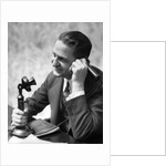 1920s Businessman Talking Into Candlestick Telephone by Anonymous