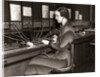1930s Woman Telephone Operator Sitting At Large Manual Switchboard Directing Calls by Anonymous