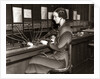 1930s Woman Telephone Operator Sitting At Large Manual Switchboard Directing Calls by Anonymous
