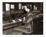 1930s Woman Telephone Operator Sitting At Large Manual Switchboard Directing Calls by Anonymous