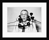 1950s 1960s Portrait Of Frazzled Businessman Trying To Answer Four Black Telephones Phones At Once by Anonymous