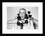 1950s 1960s Portrait Of Frazzled Businessman Trying To Answer Four Black Telephones Phones At Once by Anonymous