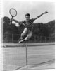 1930s Teenage Boy Tennis Player Jumping Net With Racket In Hand by Anonymous