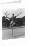 1930s Teenage Boy Tennis Player Jumping Net With Racket In Hand by Anonymous
