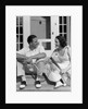 1930s Couple Man Woman In Tennis Whites Holding Racquets Sitting Talking On Steps In Front Of House Outdoor by Anonymous