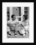 1930s Couple Man Woman In Tennis Whites Holding Racquets Sitting Talking On Steps In Front Of House Outdoor by Anonymous