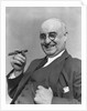 1930s Elderly Businessman In 3-Piece Suit and Glasses Leaning Back With Cigar In Hand by Anonymous