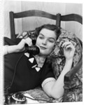 1930s Young Brunette Woman Reclining On Pillows Cigarette In Hand Talking On Telephone by Anonymous