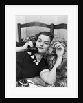 1930s Young Brunette Woman Reclining On Pillows Cigarette In Hand Talking On Telephone by Anonymous