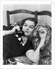1930s Young Brunette Woman Reclining On Pillows Cigarette In Hand Talking On Telephone by Anonymous