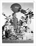 1950s Father With Son Holding Balloon Surrounded By Toys and Stuffed Animals by Anonymous