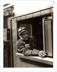 1920s 1930s 1940s Railroad Train Engineer Looking Out Window Of Locomotive Cab Driving The Steam Engine by Anonymous