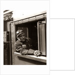1920s 1930s 1940s Railroad Train Engineer Looking Out Window Of Locomotive Cab Driving The Steam Engine by Anonymous
