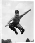 950s Boy Jumping Up by Anonymous