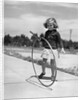 1930s Girl Playing With Hoop And Stick On Sidewalk by Anonymous