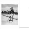 1930s Girl Playing With Hoop And Stick On Sidewalk by Anonymous