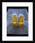 Two Glass Mugs of Beer on Table by Anonymous
