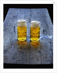 Two Glass Mugs of Beer on Table by Anonymous