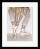 Ballerina adjusting toe shoe by Anonymous