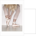Ballerina adjusting toe shoe by Anonymous