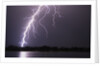 Lightning Striking Ground Near Residential Lake by Anonymous