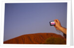 Tourist photographing Ayers Rock in the Australian Outback by Anonymous