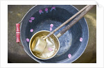 Ladling peach blossoms from a water pail by Anonymous