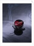 Burning incense on top of bowl of petals by Anonymous